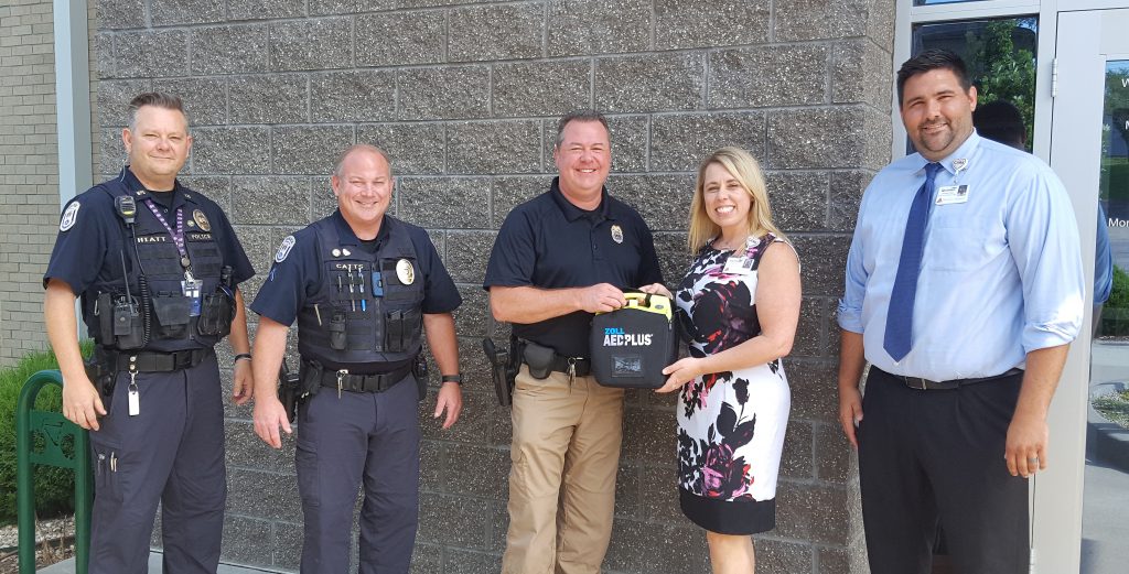 WMMC's Darinda Reberry donating AED to Warrensburg's Police Chief Rich Lockhart